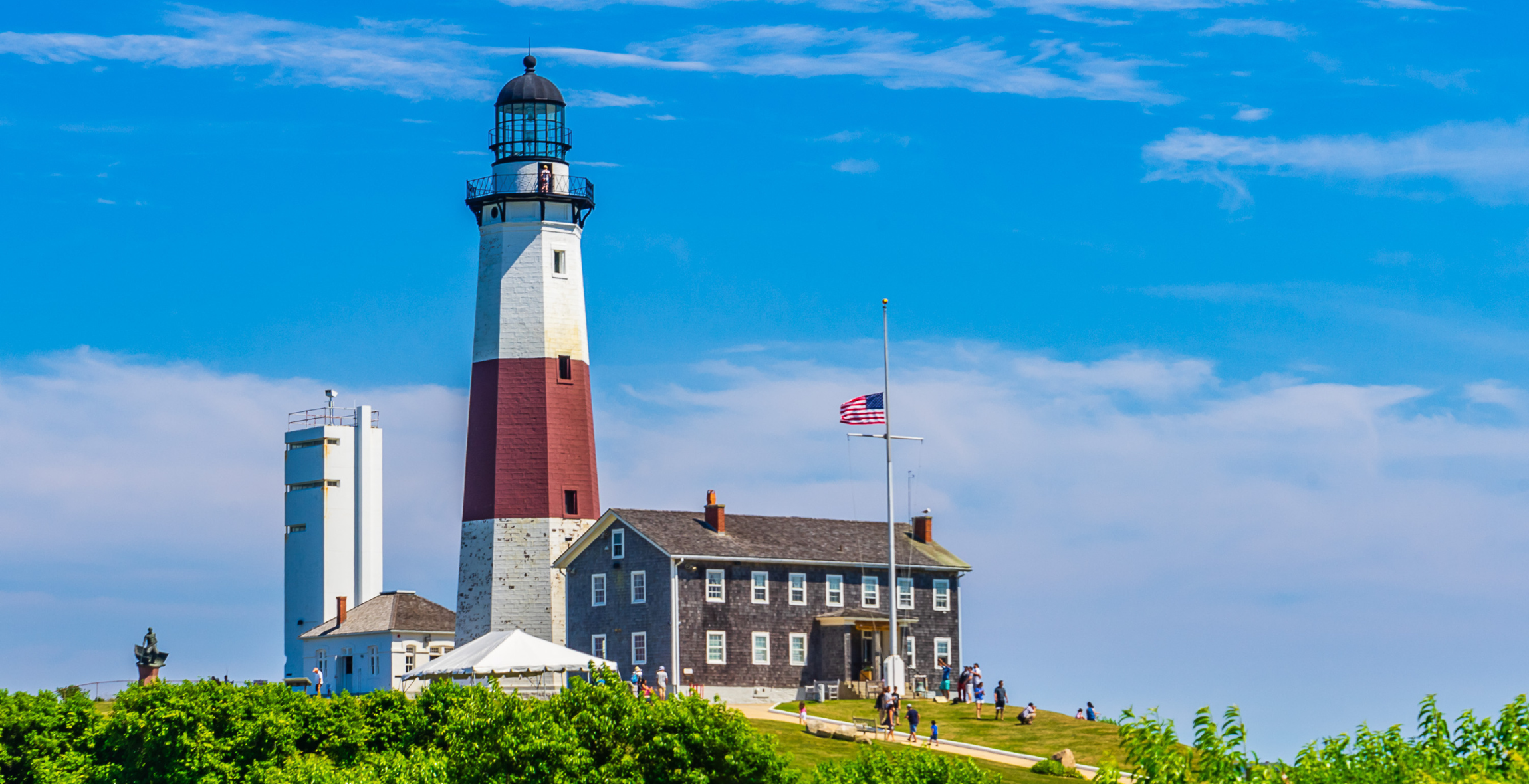 Montauk Lighthouse behind an American flag on Long Island, New York.