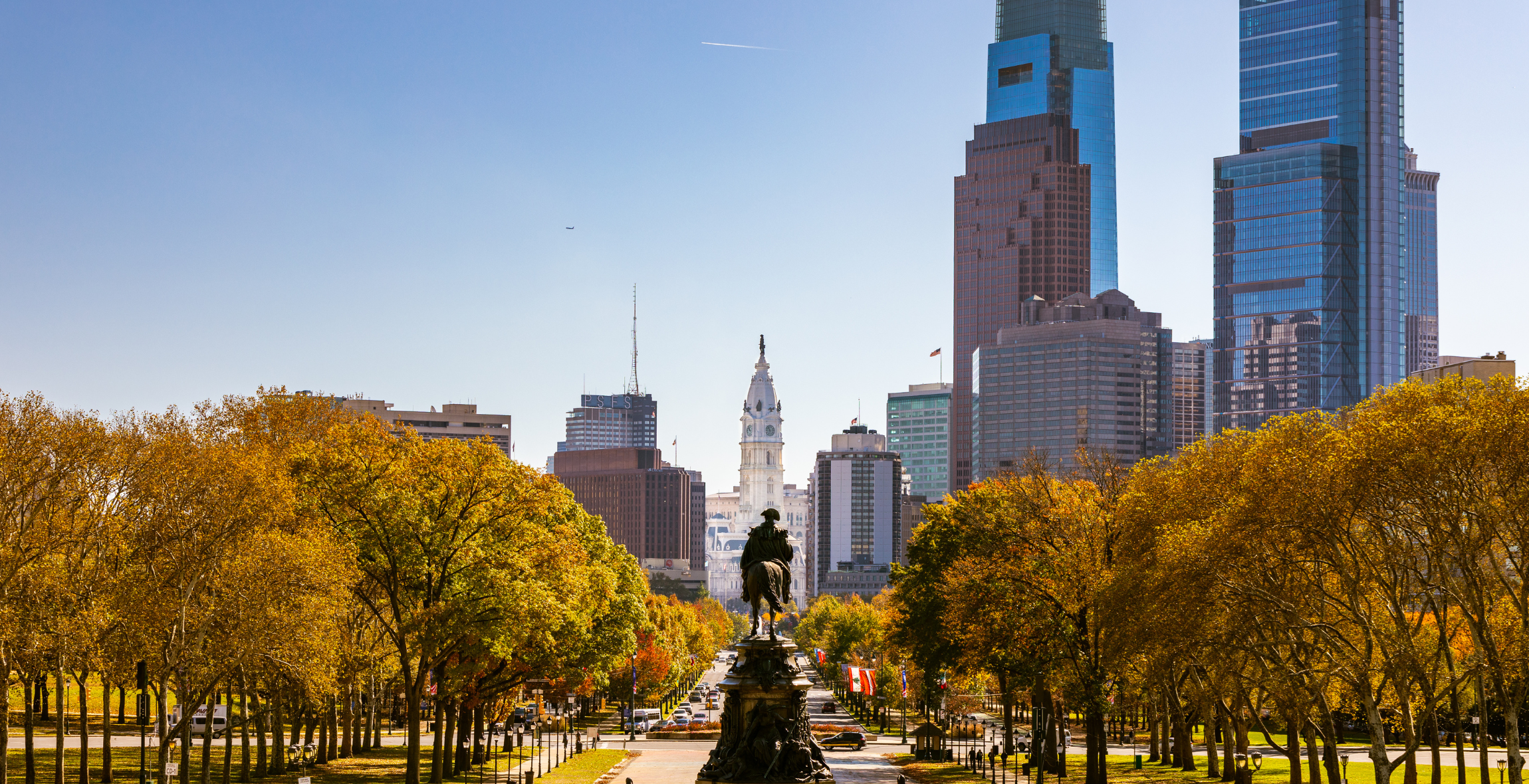 Equestrian statue of Ulysses S. Grant in front of yellow trees and high buildings