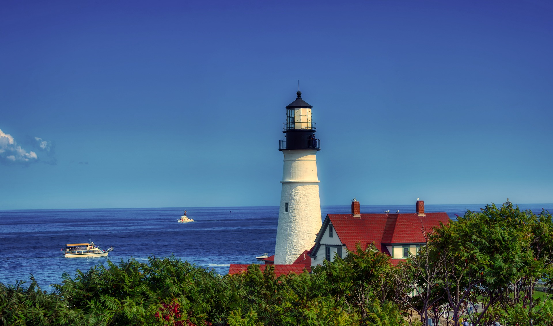 a lighthouse and building with a red roof